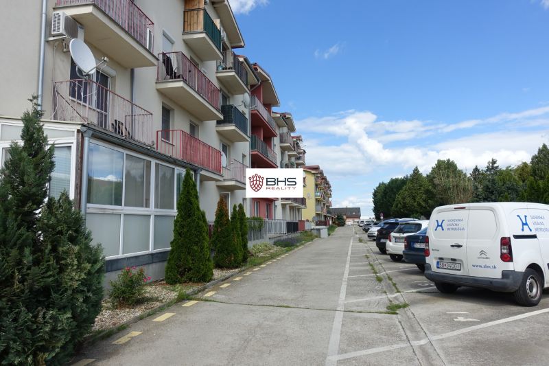 Row houses and parked cars on Agátová Street in Miloslavov next to 2-bedroom apartments.