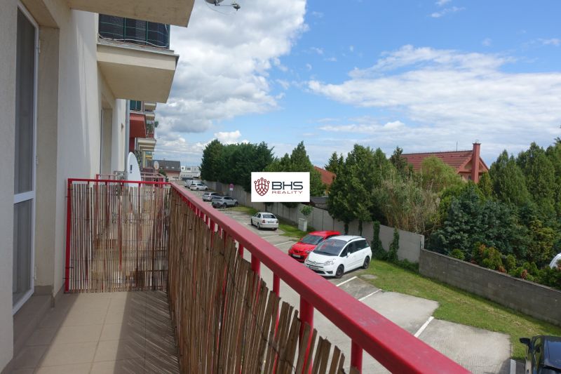 The balcony of a 2-room apartment on Agátová Street in Miloslavov with a view of the parking lot and greenery.