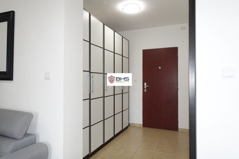The entrance hall of a 2-room apartment with a large wardrobe and tiled floor.
