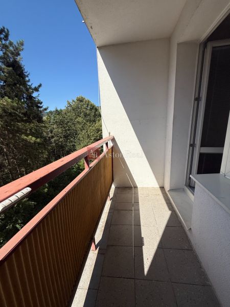 A balcony with a view of greenery in a 3-room apartment on Tulská Street, Banská Bystrica.