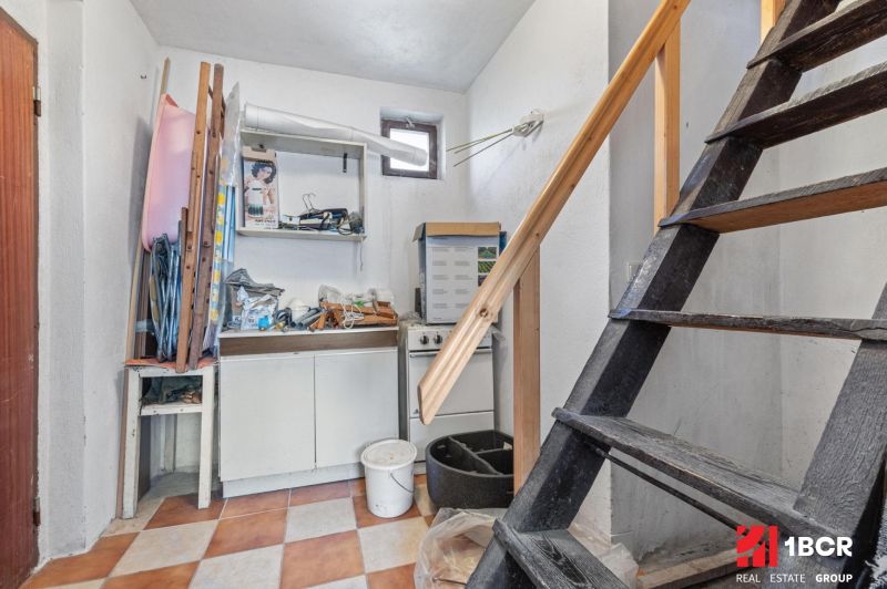 A staircase with storage space and a kitchen unit in a family house.