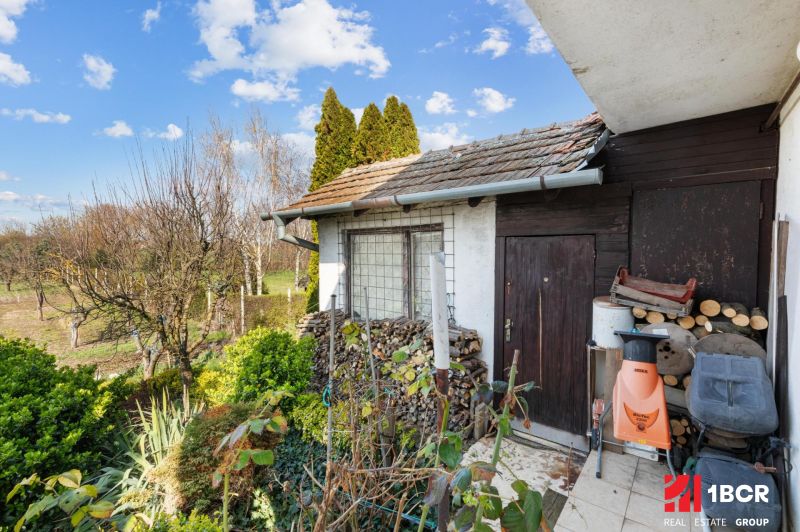 A family house on Legionárska Street in Mani with wood and garden tools.