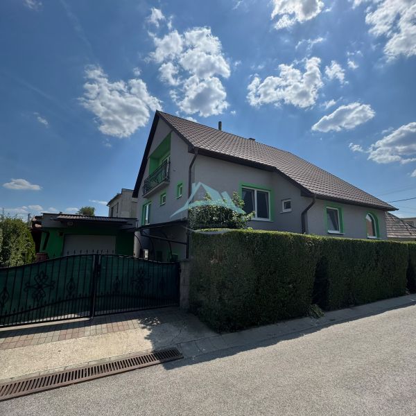 A family house on Tešmak Street in Šahy with a fence and a paved walkway.