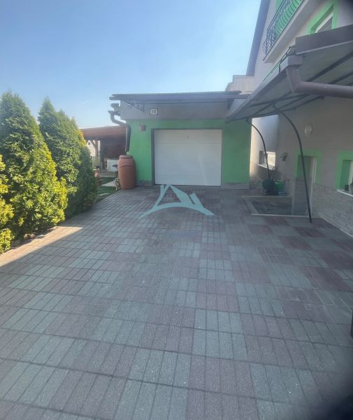 A family house on Tešmak Street in Šahy with a garage and a paved courtyard.