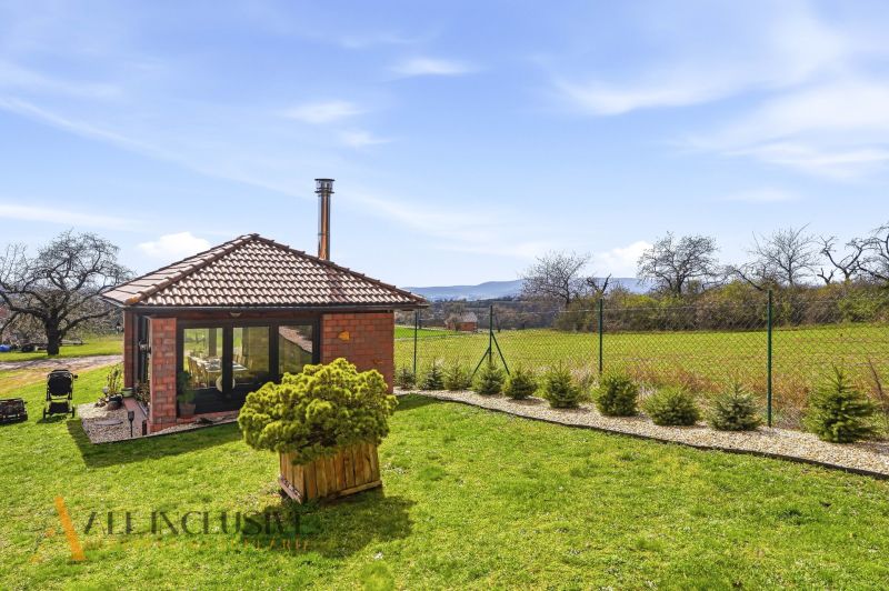 A family house in Kopanice in Krupina with a view of the garden and the surrounding countryside.