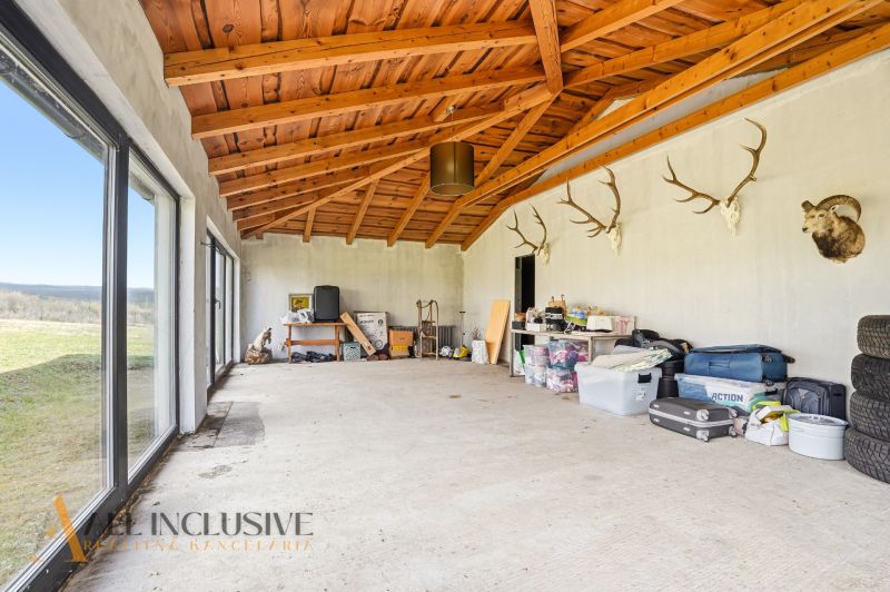 Estimating storage space in a family house with a wooden ceiling and trophies.