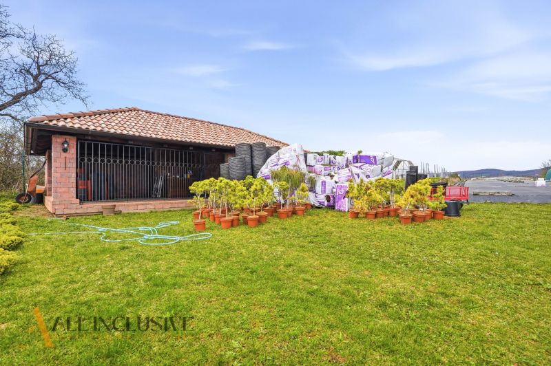 The exterior of a family house in Kopanice in Krupina with a variety of plants and garden materials.