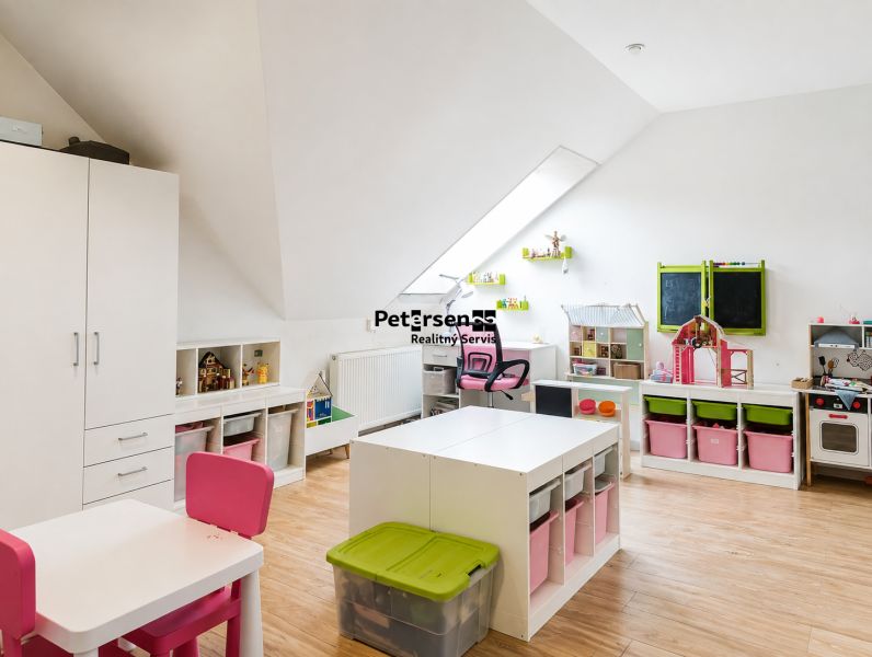 Children's room with storage spaces and toys in a 3-room apartment. Floor with wooden decor.