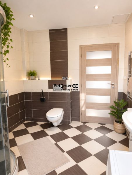 A bathroom in a 3-room apartment with brown-beige tiles and a shower.