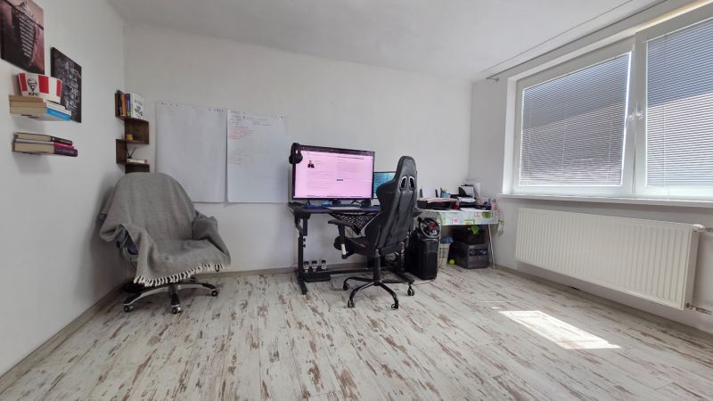 A study in a family house with a computer and a wooden decor floor.