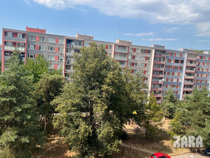 The housing estate on Družicová Street in Košice - Nad jazerom area, surrounded by greenery and trees.