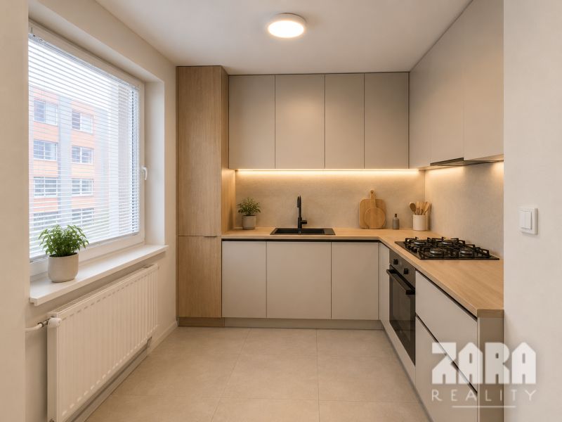 A minimalist kitchen in a three-room apartment with a wooden decor floor and a large window.