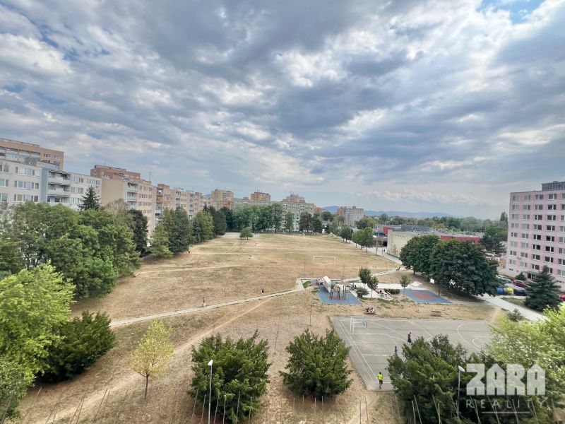Park with a playground and apartment buildings on Družicová Street, Košice - Nad jazerom district.