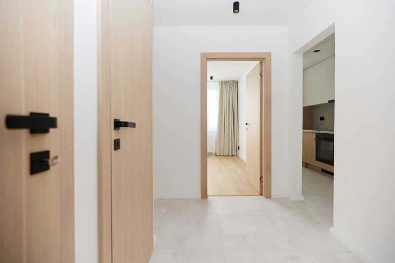 A bright hallway with a wood-effect floor in a 3-room apartment.