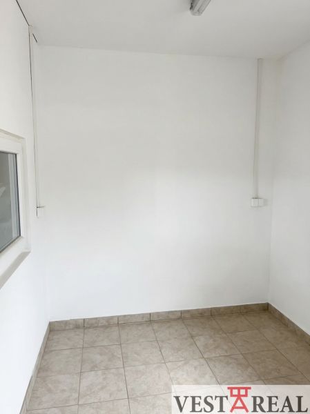 Interior of warehouses and halls with white walls and tiled floors.