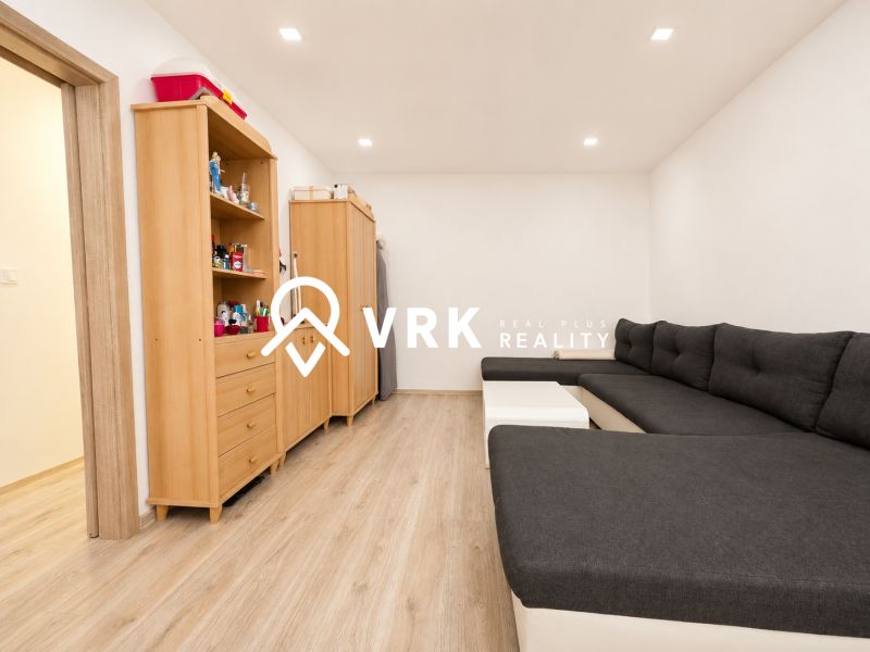 A comfortable sofa set and storage furniture in a studio apartment with a wooden decor floor.
