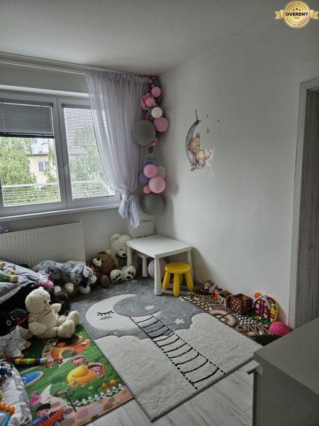 Children's room in a 4-room apartment with wall decor and toys.