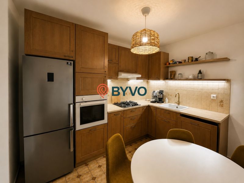 A kitchen with a wooden decor includes a refrigerator, an oven, and a coffee maker in a 3-room apartment.