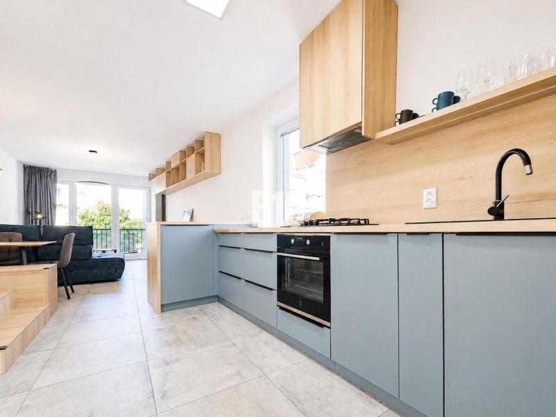 Kitchen in the Holiday Apartment with wood-patterned flooring and garden view.