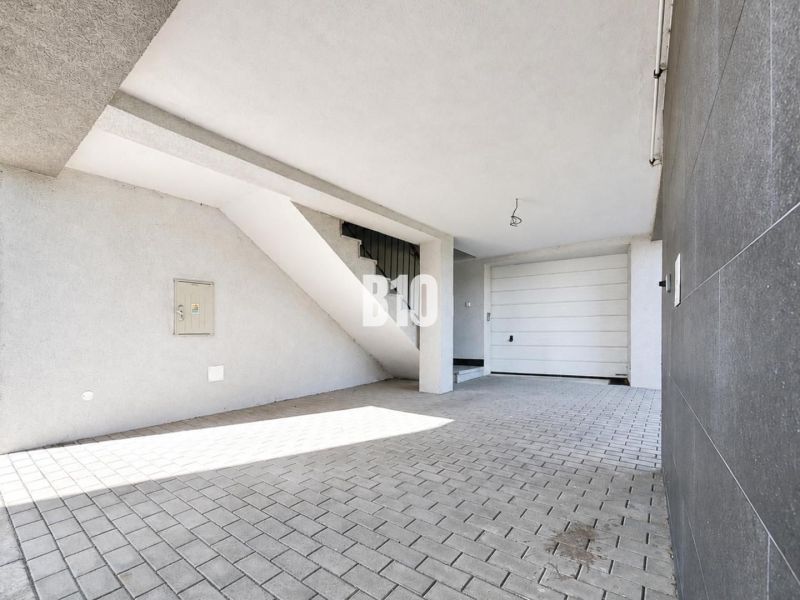 Covered parking space at a recreational apartment in Nitra with access to stairs.