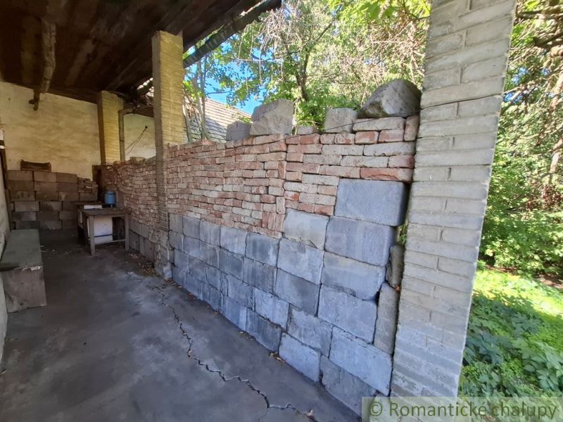 An incomplete wall made of bricks and blocks in a shelter at the plots - housing in Nova Vieska.