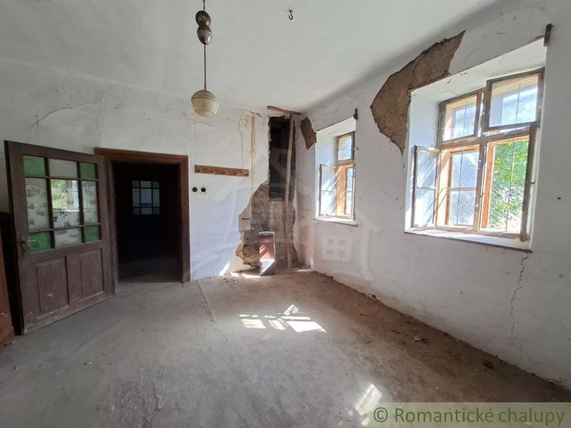 Interior with wooden doors and damaged walls in the section Real Estate - Housing.