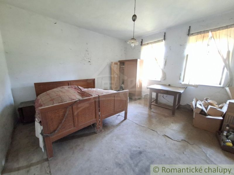 A room with a bed, table, and wardrobe, interior under construction Land - living.