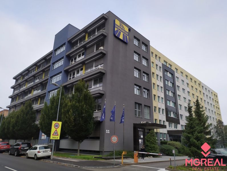 Offices in Bratislava - Ružinov on a busy street, next to greenery and parking.