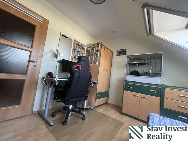 Home office in a 4-room apartment with wood-decor flooring, a desk, and a chair.