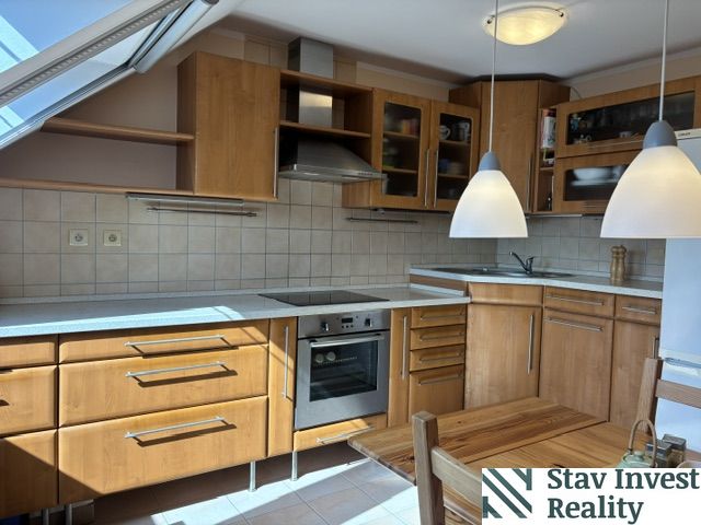 A kitchen in a 4-room apartment with a wooden decor floor and built-in appliances.