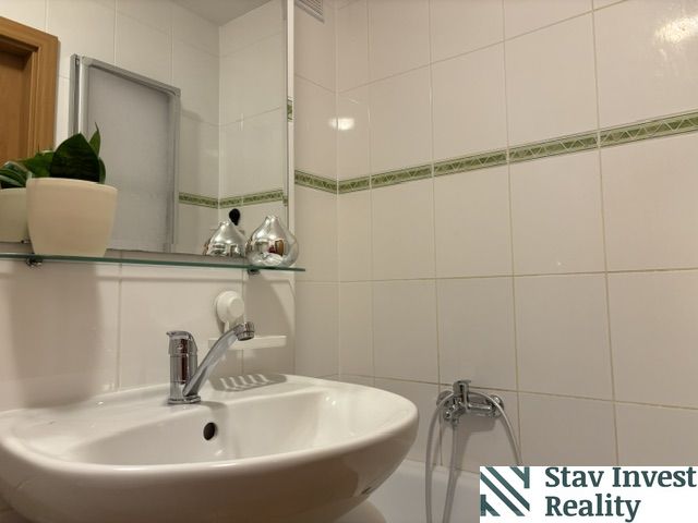 A bathroom with sanitary ceramics and beige tiles in a 4-room apartment.