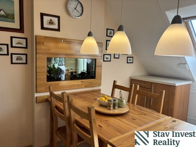 A dining room with a solid wood table in a 4-room apartment with wooden decor.