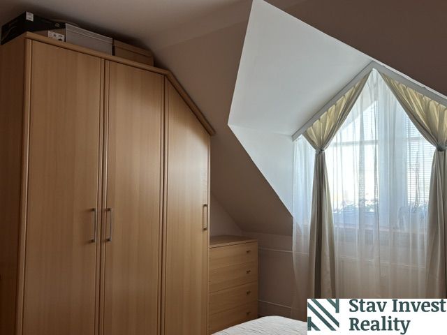 A bedroom in a 4-room apartment with a corner wardrobe and a skylight.