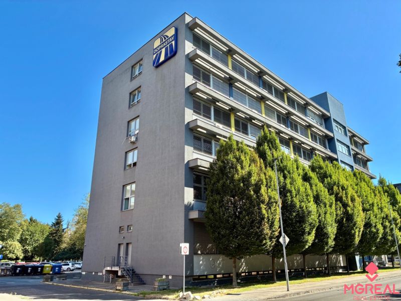 An office building with several floors and trees in Bratislava - Ružinov.