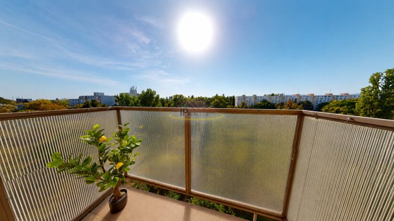 A balcony in a 3-room apartment on Šándorova Street with a view of greenery in Bratislava.