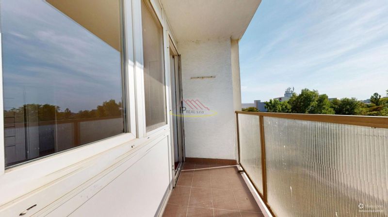 The balcony of a 3-room apartment on Šándorova Street in Bratislava - Ružinov with a view of greenery.