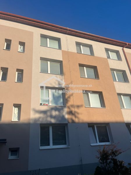 The facade of an apartment building in Rožňava offering a 2-room apartment, bright facade shades.