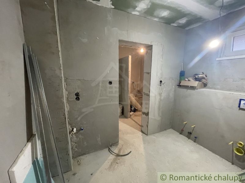 Interior of a family house under construction, with bare walls and unfurnished rooms.
