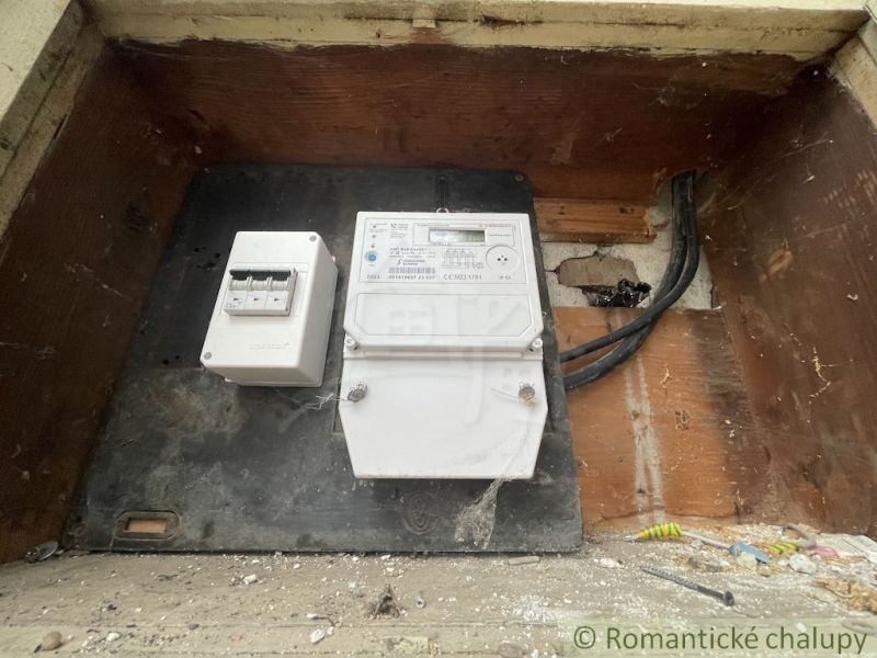 Electric meter and wiring in a family house, Šurany, hidden in a wooden recess.