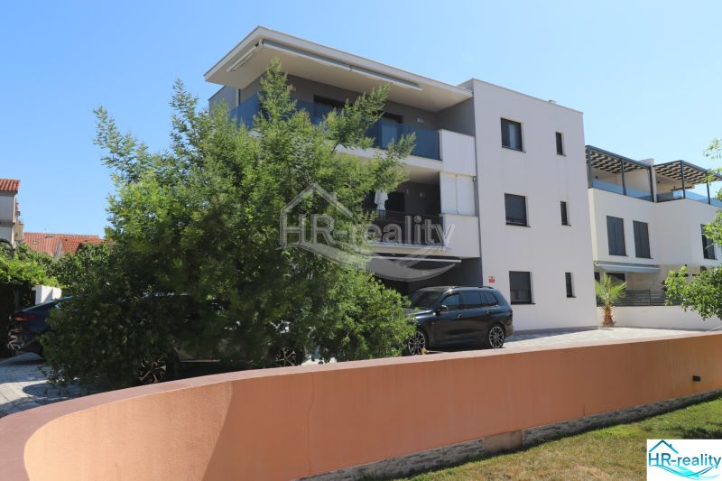 A recreational apartment in Srima with modern architecture and greenery.