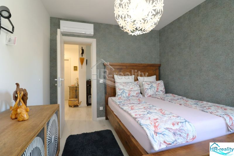 Recreational apartment with a bedroom, wooden decor, and decorative lighting.