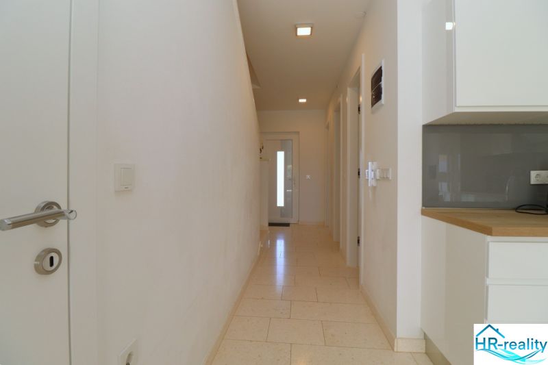 Hallway with white walls and tiles, Recreational apartment.