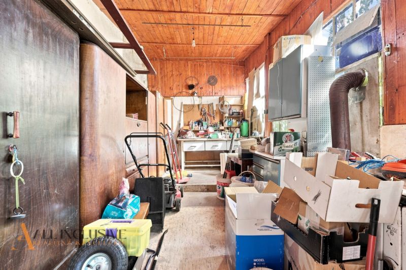 Storage space in a family house with tools and cardboard boxes.