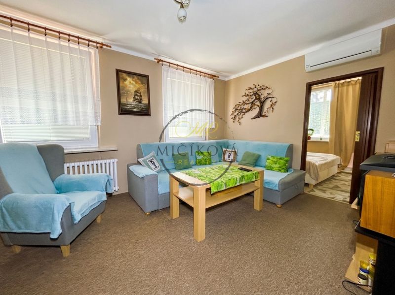 Living room with comfortable seating in a 4-room apartment, entrance to the room.
