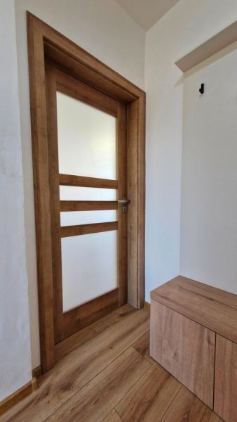 Wooden doors and a floor with a wooden decor in a 3-room apartment.