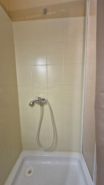 Shower corner with ceramic tiles in a 3-room apartment.