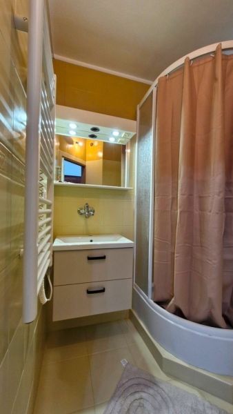 A bathroom with a shower and a sink in a 3-room apartment.