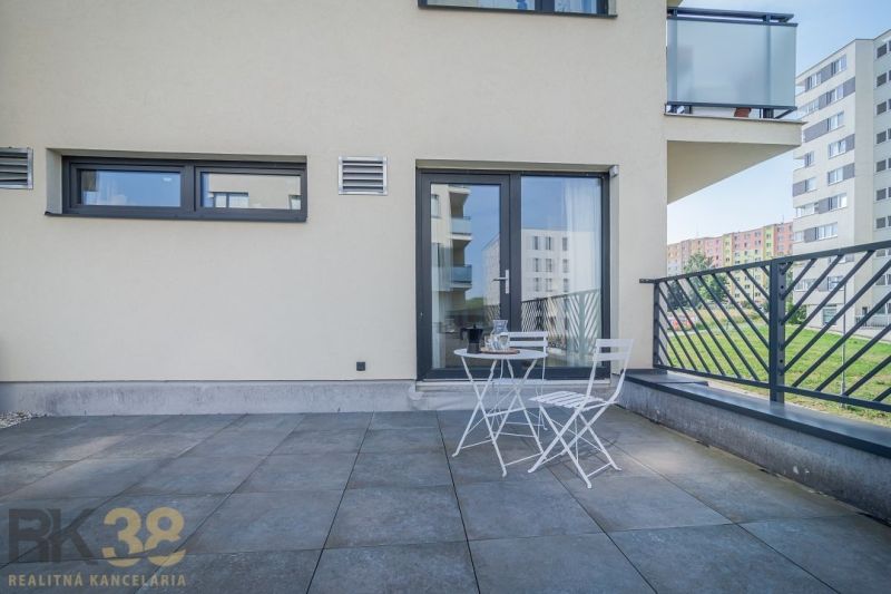 Terrace of a 4-room apartment on Dlhé Hony in Poprad with white seating.