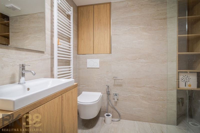 A bathroom in a 4-room apartment with wooden decor and modern sanitary equipment.