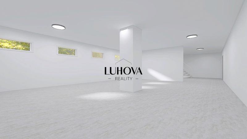 Large white interior with windows and a column suitable for commercial spaces.